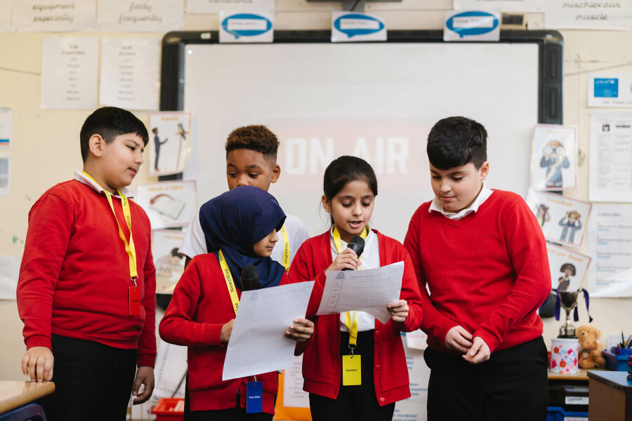 pupils presenting their news reports